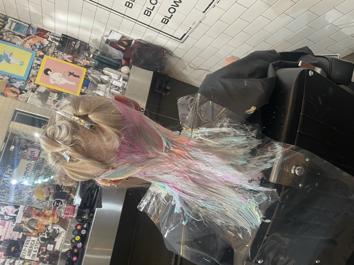 Long hair sectioned for cut — house call